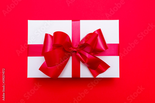 Top view White gift box ribbon flat lay red background.Christmas concept.