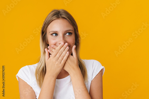 Cheerful beautiful girl posing and covering her mouth