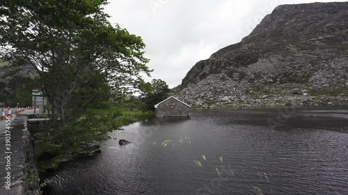 A windy mountain lake scene with boathouse on Llyn Ogwen in Snowdonia photo