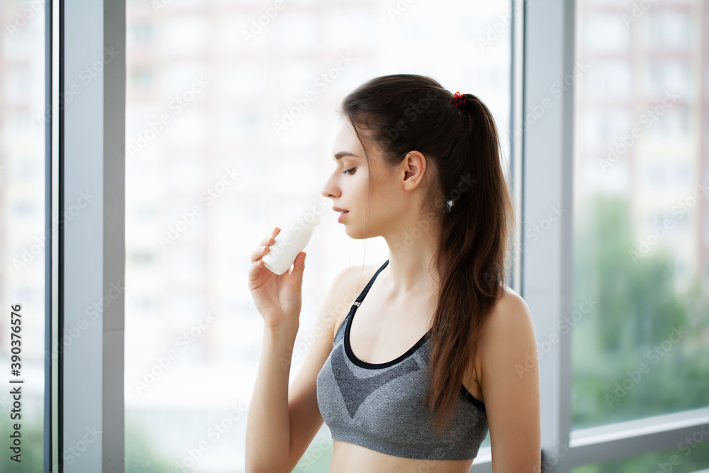 Young beautiful woman drinking from plastic bottle of yogurt Young beautiful woman drinking from plastic bottle of yogurt
