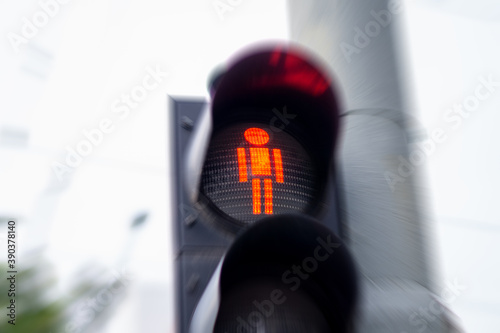 traffic light shines red for pedestrians. blur and motion effect