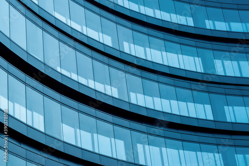 the glass facade of the building reflects the blue sky. financial centers. Background. Wallpaper