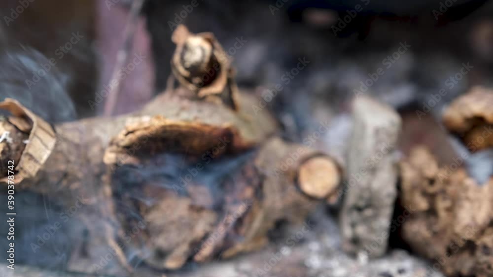 The logs were burned with ashes and white smoke emitted. The logs were burned with ashes and white smoke emitted.