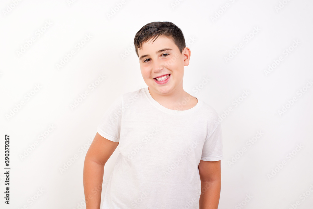 Portrait of successful Caucasian young boy standing against white background , smiling broadly with self-assured expression. Confidence and business concept. Portrait of successful Caucasian young boy standing against white background , smiling broadly with self-assured expression. Confidence and business concept.
