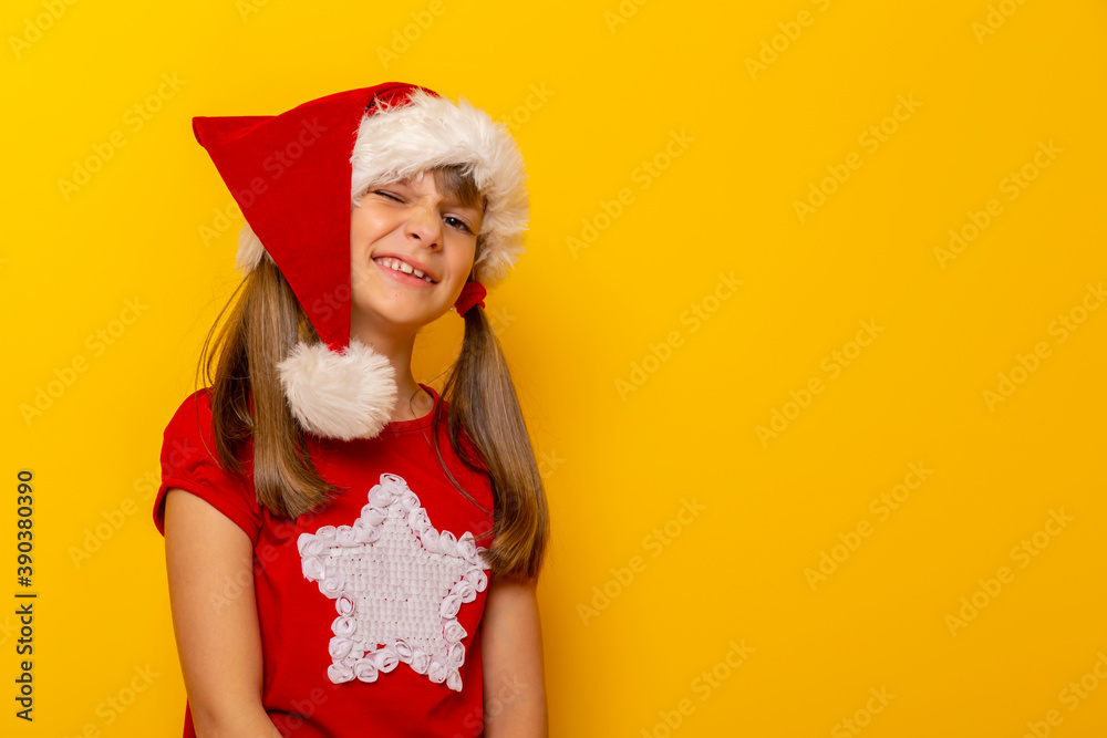 Little girl wearing Santa hat winking Little girl wearing Santa hat winking