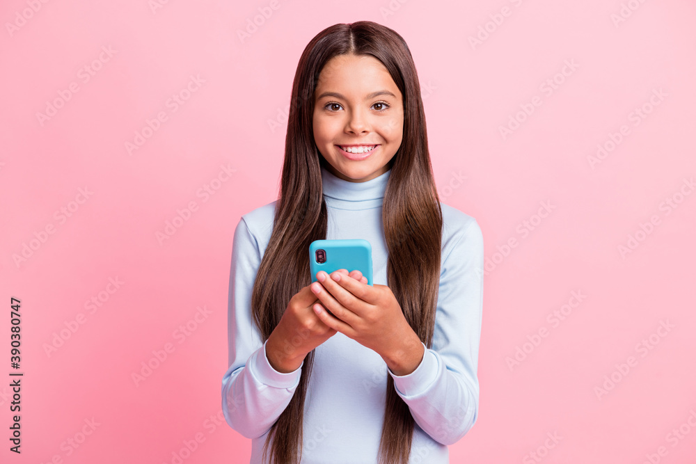 Portrait of charming cheerful brown-haired girl using device app 5g wi-fi isolated over pink pastel color background Portrait of charming cheerful brown-haired girl using device app 5g wi-fi isolated over pink pastel color background