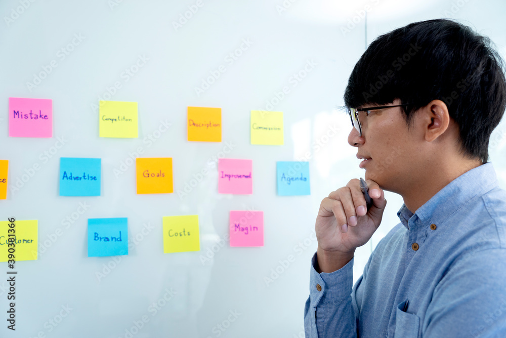 A businessman watching the pose note pad on the glass A businessman watching the pose note pad on the glass