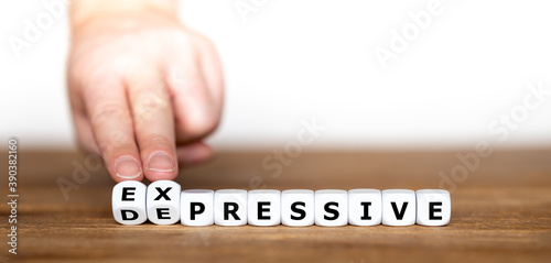 Hand turns dice and changes the word "depressive" to "expressive".
