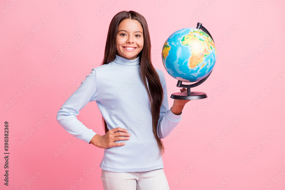 Portrait of lovely cheerful girl holding in hands globe college lesson isolated over pink pastel color background Portrait of lovely cheerful girl holding in hands globe college lesson isolated over pink pastel color background