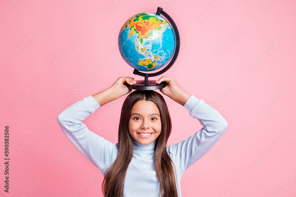 Portrait of lovely cheerful smart funny girl carrying globe on head lesson isolated over pink pastel color background Portrait of lovely cheerful smart funny girl carrying globe on head lesson isolated over pink pastel color background