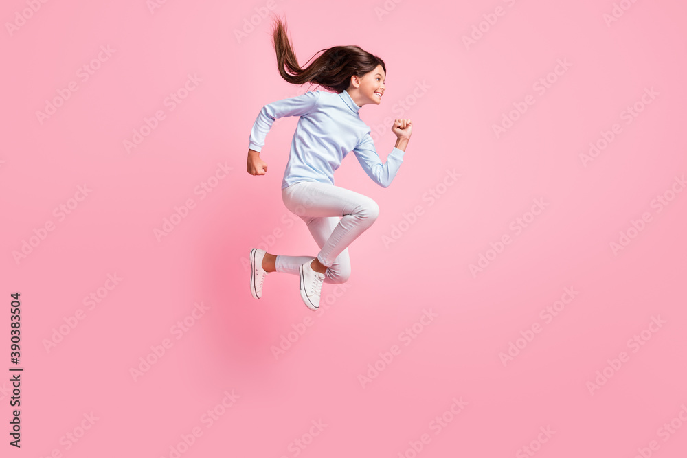Full length body size view of pretty motivated cheerful girl jumping running fast speed energy isolated over pink color background