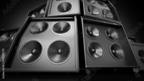 Speakers tower playing in closeup , stacked tower of many subwoofer membranes vibrating playing loud music.