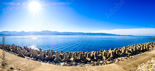 concrete wave breaker at a coast photo