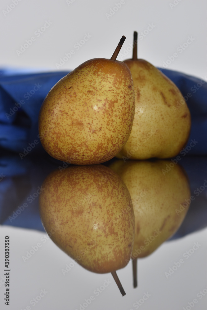 fresh pear on table with reflection. selective focus.. fresh pear on table with reflection. selective focus..