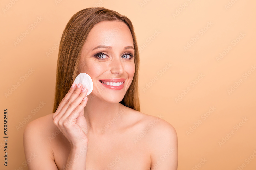 Close-up view portrait of her she nice-looking attractive lovely charming perfect cheerful nude naked girl cleansing pure soft silky skin natural tonic water isolated over beige pastel background Close-up view portrait of her she nice-looking attractive lovely charming perfect cheerful nude naked girl cleansing pure soft silky skin natural tonic water isolated over beige pastel background