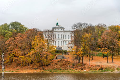 Panoramic autumn view of the view of the Bogoroditsky palace and park in Bogoroditsk. Autumn fantastic view of the palace with orange-yellow trees in the park.