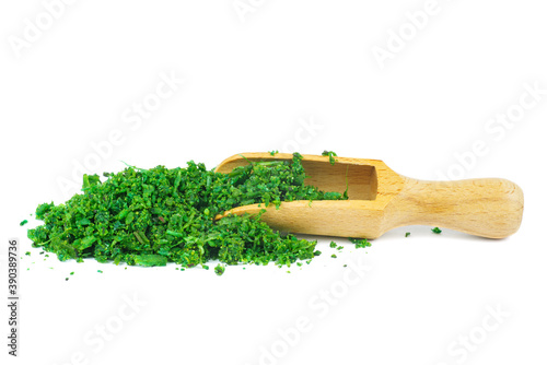 Pile of asafoetida(or hing) with wooden scoop isolated on a white background