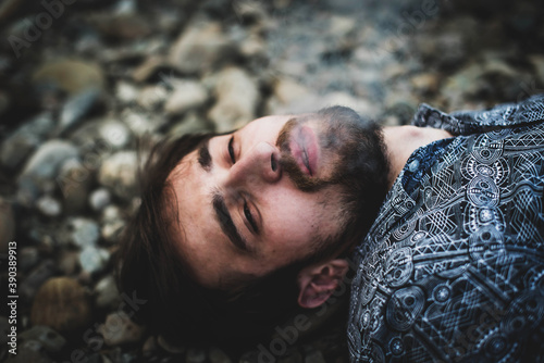 young caucasian man smoking joint with weed in the stones on the street. Addict man in action. The concept of drug abuse and traffic. © MartaKlos