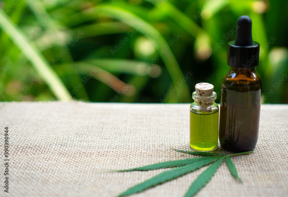 Glass bottles containing hemp oil and seeds and plants, ecology, marijuana, herbs, medicine, cbd oil from bottles, ..Medical herbal therapy concept Glass bottles containing hemp oil and seeds and plants, ecology, marijuana, herbs, medicine, cbd oil from bottles, ..Medical herbal therapy concept