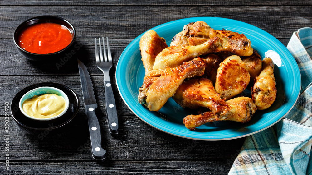 Spicy chicken drumsticks with ketchup and mustard Spicy chicken drumsticks with ketchup and mustard