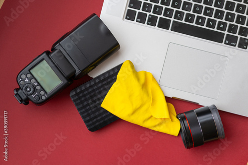 Camera gear red background top view copy space