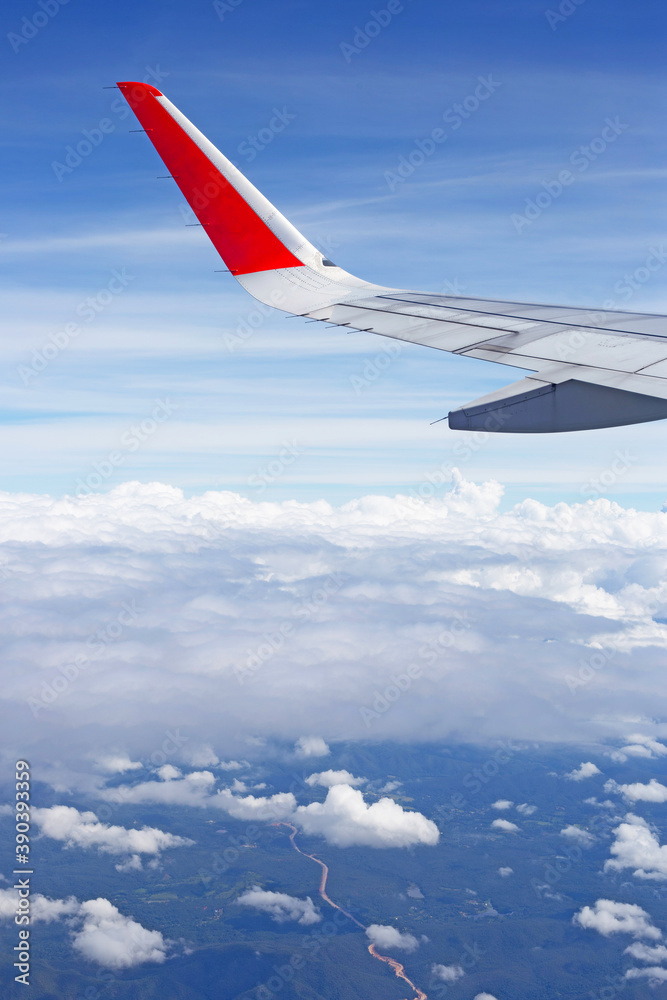 View of land, sky, cloud and wing of airplane from window View of land, sky, cloud and wing of airplane from window