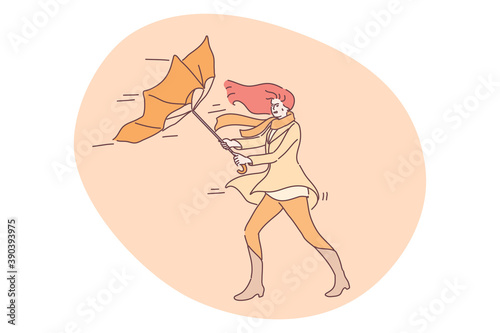 Storm, nature, autumn concept. Young unhappy angry woman cartoon character holding blowing on wind umbrella on street. Autumnal windy bad stormy weather with rain and gusting wind vector illustration.