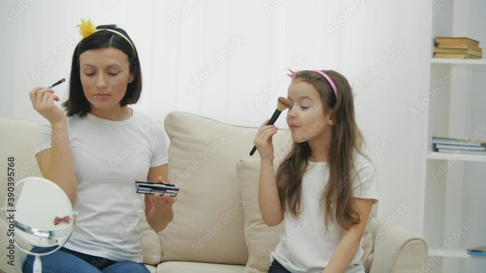 4k slowmotion video of mother and daughter applying make up. 4k slowmotion video of mother and daughter applying make up.