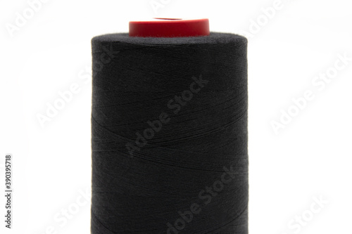 Black thread for sewing on a white background