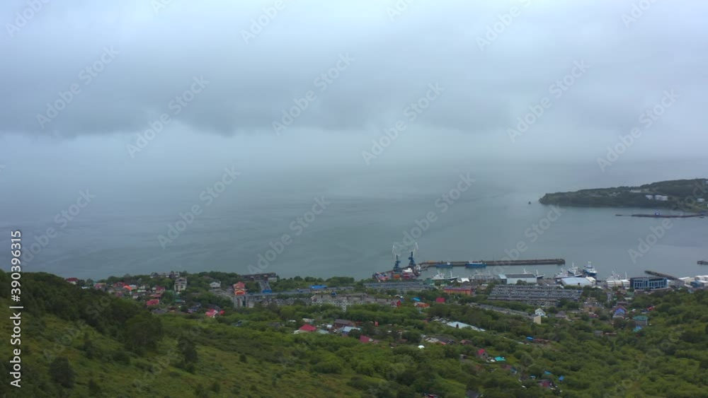 Aerial view of foggy Petropavlovsk-Kamchatsky from the observation deck on Mishennaya Sopka. Amazing nature of Kamchatka. Avacha Bay. Travel to the Kamchatka Peninsula. Aerial view of foggy Petropavlovsk-Kamchatsky from the observation deck on Mishennaya Sopka. Amazing nature of Kamchatka. Avacha Bay. Travel to the Kamchatka Peninsula.
