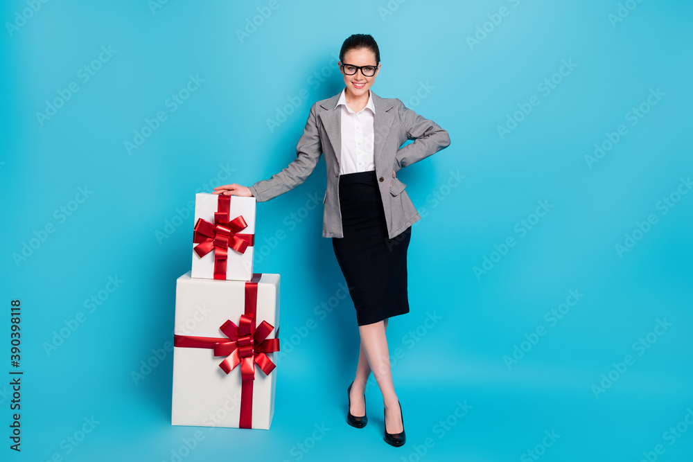 Full length photo boss girl have pile stack big present wear black grey blazer jacket isolated blue color background Full length photo boss girl have pile stack big present wear black grey blazer jacket isolated blue color background