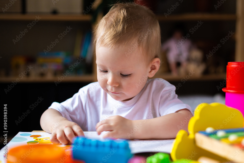 Cute little girl playing alone with many colorful toys Cute little girl playing alone with many colorful toys