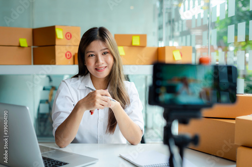 Starting small businesses SME owners female entrepreneurs Live chatting with customers to receive and review online orders to prepare to pack boxes, sell to customers, sme business ideas online.