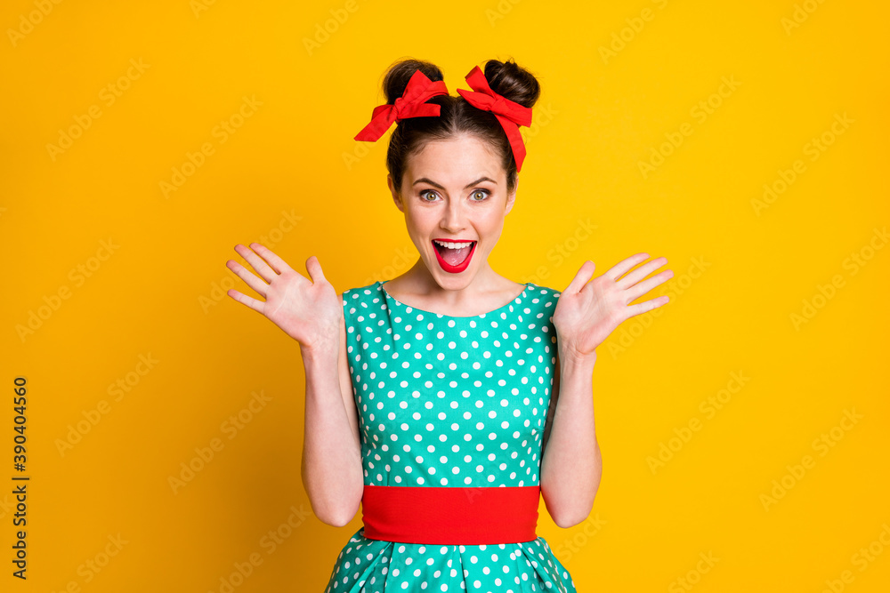 Portrait of pretty glamorous cheerful girl wearing dotted dress good news reaction isolated over vibrant yellow color background Portrait of pretty glamorous cheerful girl wearing dotted dress good news reaction isolated over vibrant yellow color background