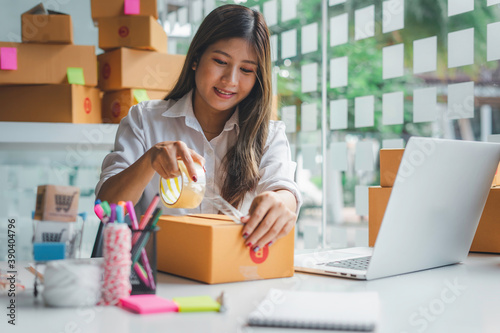 Starting small businesses SME owners female entrepreneurs packing products Receive and review orders online to prepare to pack boxes, sell to customers, sme business ideas online.