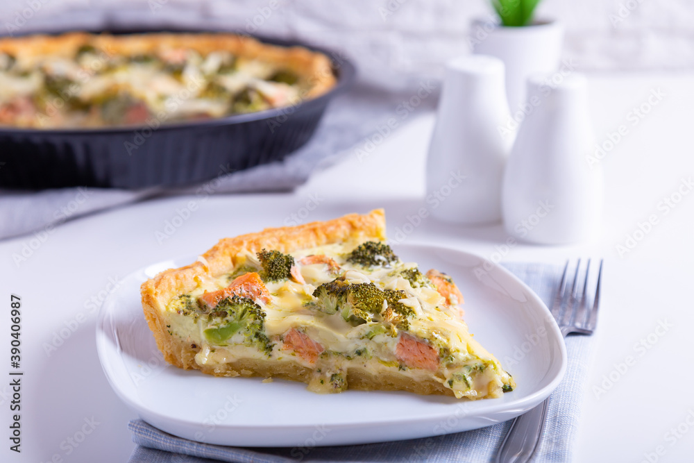 Quiche (open pie) with trout, broccoli and cheese. Homemade unsweetened pastries, traditional pie. Close-up. Quiche (open pie) with trout, broccoli and cheese. Homemade unsweetened pastries, traditional pie. Close-up.