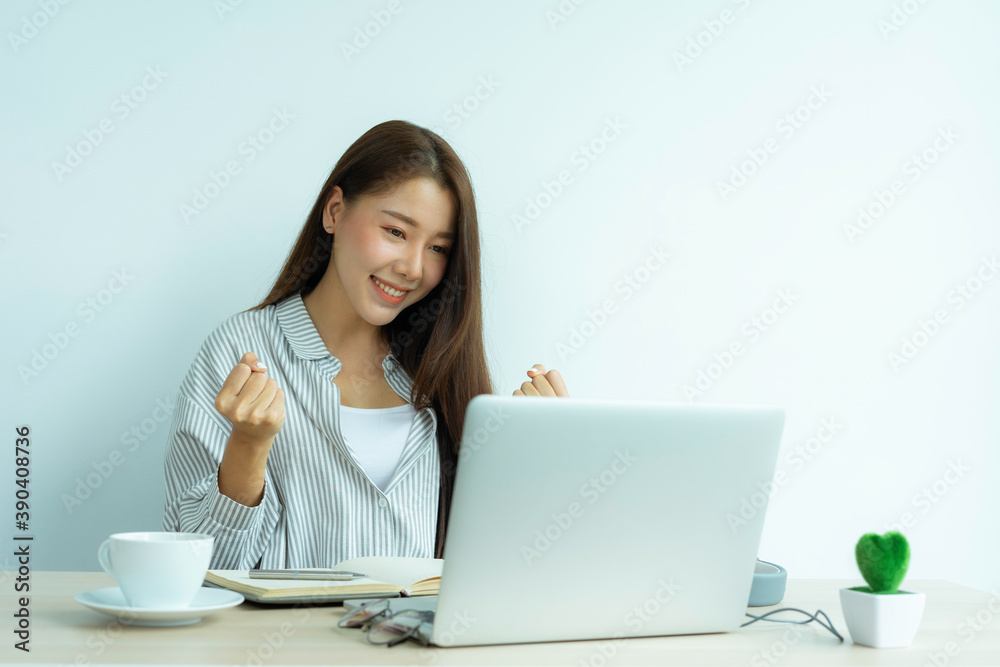 Asian woman enjoys herself while using laptops and the internet in the office. Business and marketing concept. On line shopping and business success. Happy mood when finished the working job. Asian woman enjoys herself while using laptops and the internet in the office. Business and marketing concept. On line shopping and business success. Happy mood when finished the working job.