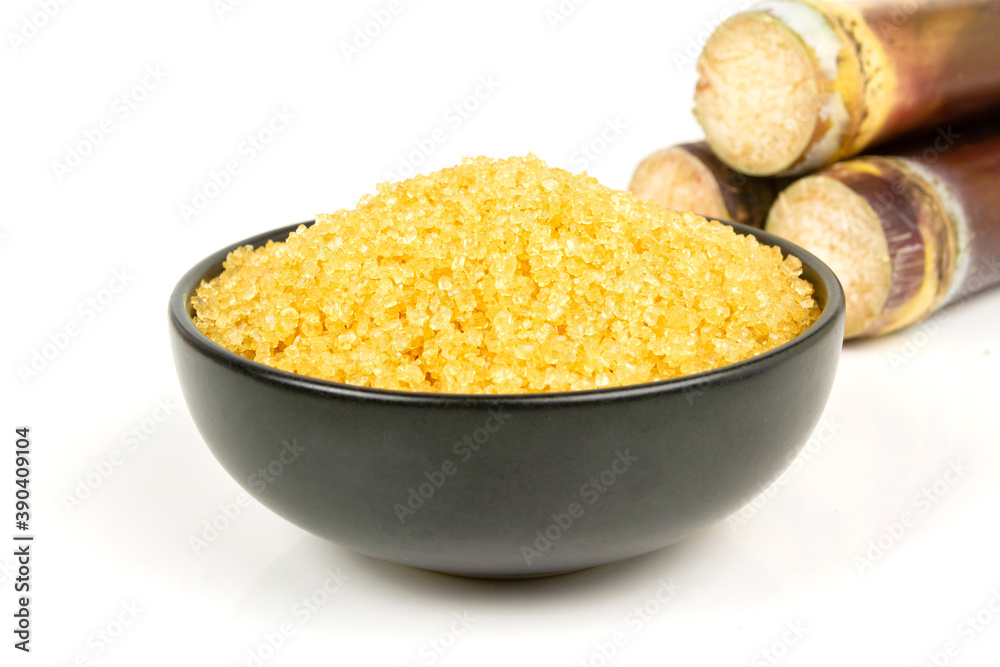Sugar from sugarcane in black bowl and pile of sugarcane isolated on white background. Sugar from sugarcane in black bowl and pile of sugarcane isolated on white background.