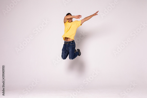 Happy excited young man jumping and celebrating success isolated on a white background