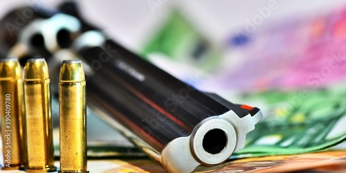 Konstfotografi Handgun and ammunition resting on euro banknotes, symbolizing illegal activities