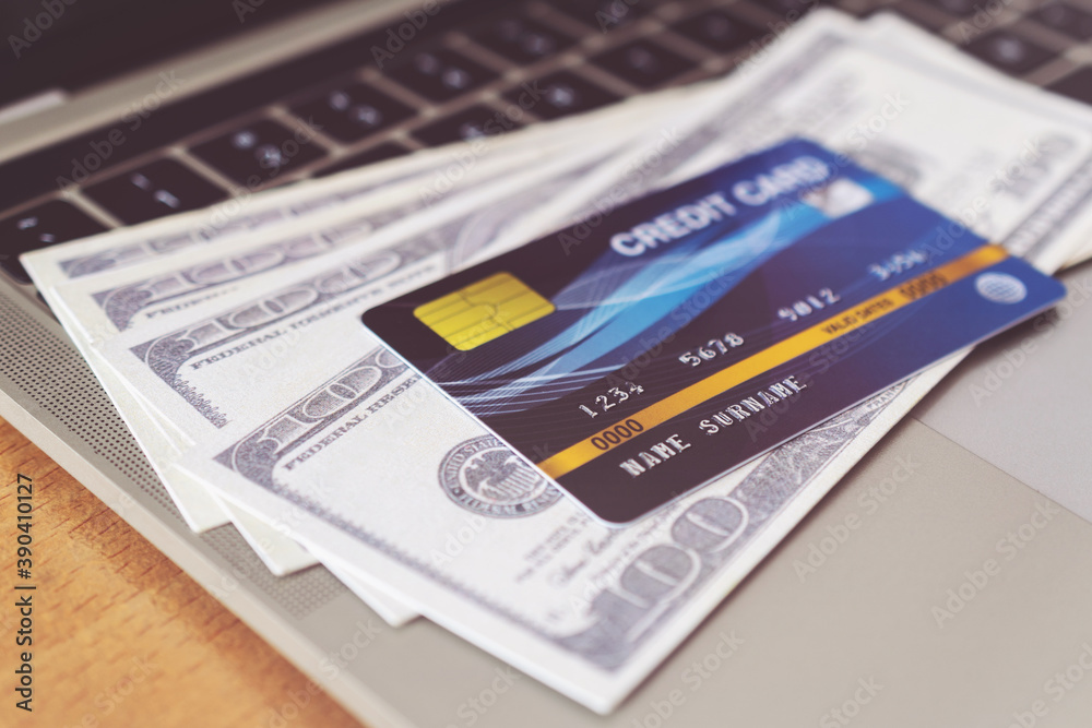 Credit card and money on a computer keyboard. shopping online concept, Online payment Credit card and money on a computer keyboard. shopping online concept, Online payment