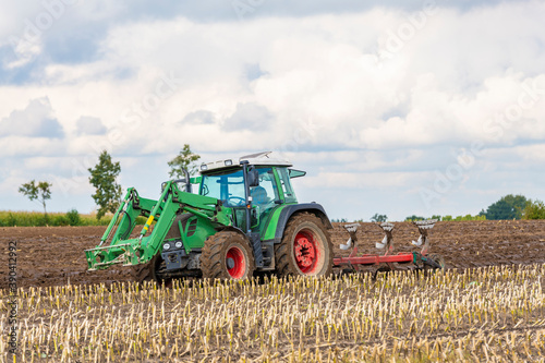 Tractor with reversible plough during field work