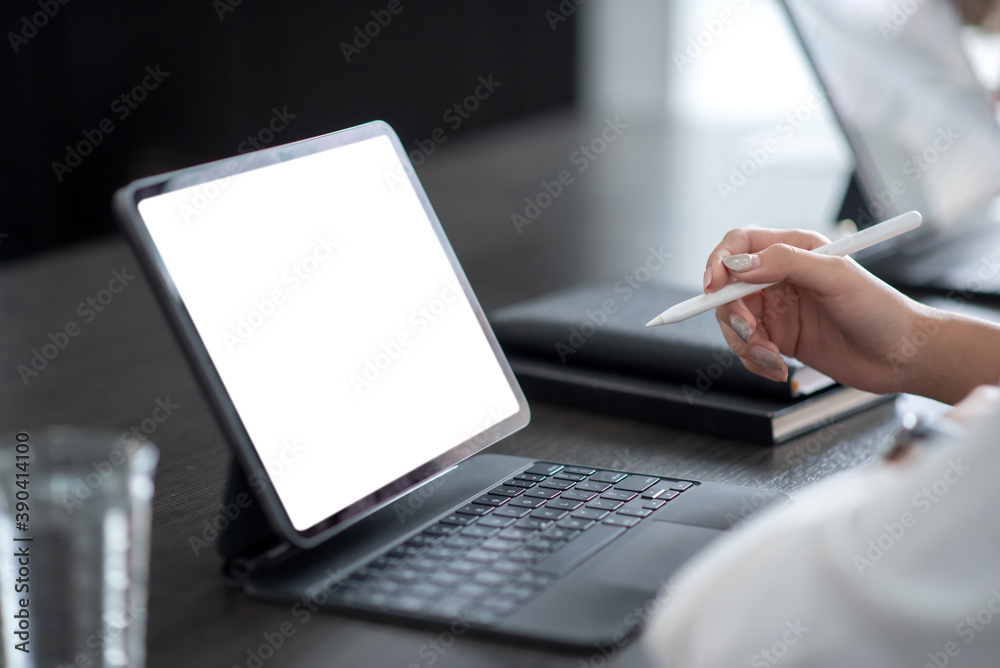 Close up. Hand businesswoman using digital tablet on white screen on table. Mock up. Close up. Hand businesswoman using digital tablet on white screen on table. Mock up.