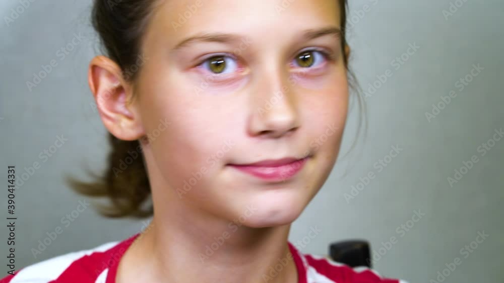 Little girl using finger for keeping mouth open and shaking wobbly baby