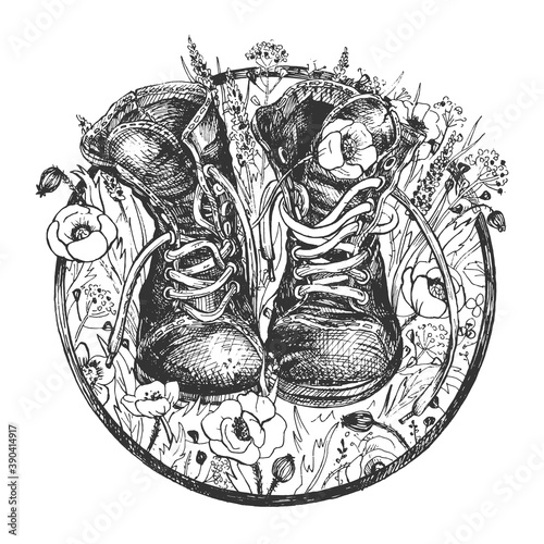 Old hiking boots on wildflower