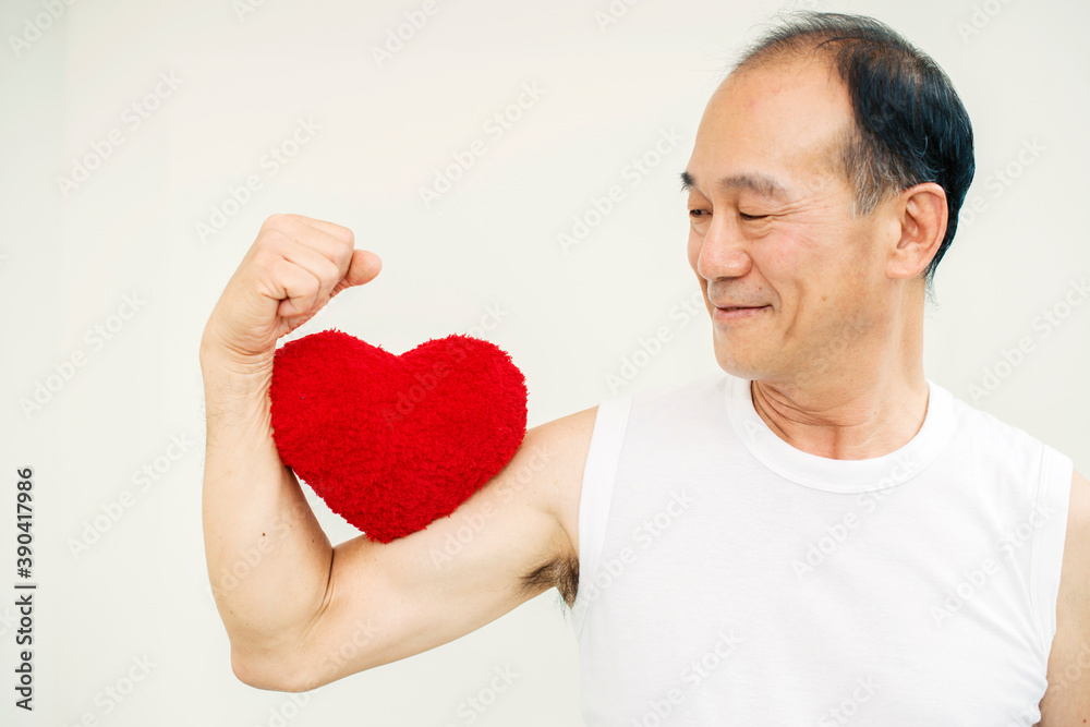 Way to a healthy heart through exercise concept - Happy healthy elderly asian man holding a red heart and leave space for adding your content on background look old or vintage style. Way to a healthy heart through exercise concept - Happy healthy elderly asian man holding a red heart and leave space for adding your content on background look old or vintage style.