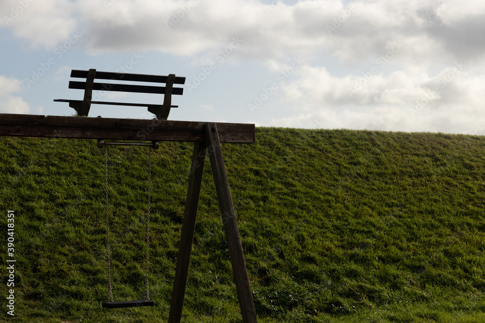 Park bench facing clouds green grass Park bench facing clouds green grass