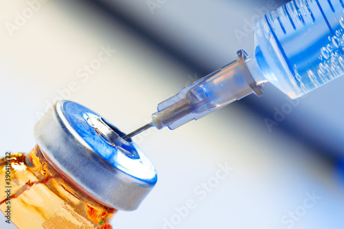 Medical vial with medication and syringe close up