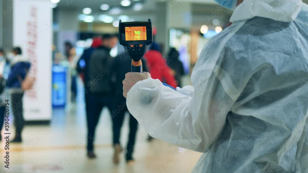 Temperature in a public place is getting measured with a thermal camera Temperature in a public place is getting measured with a thermal camera