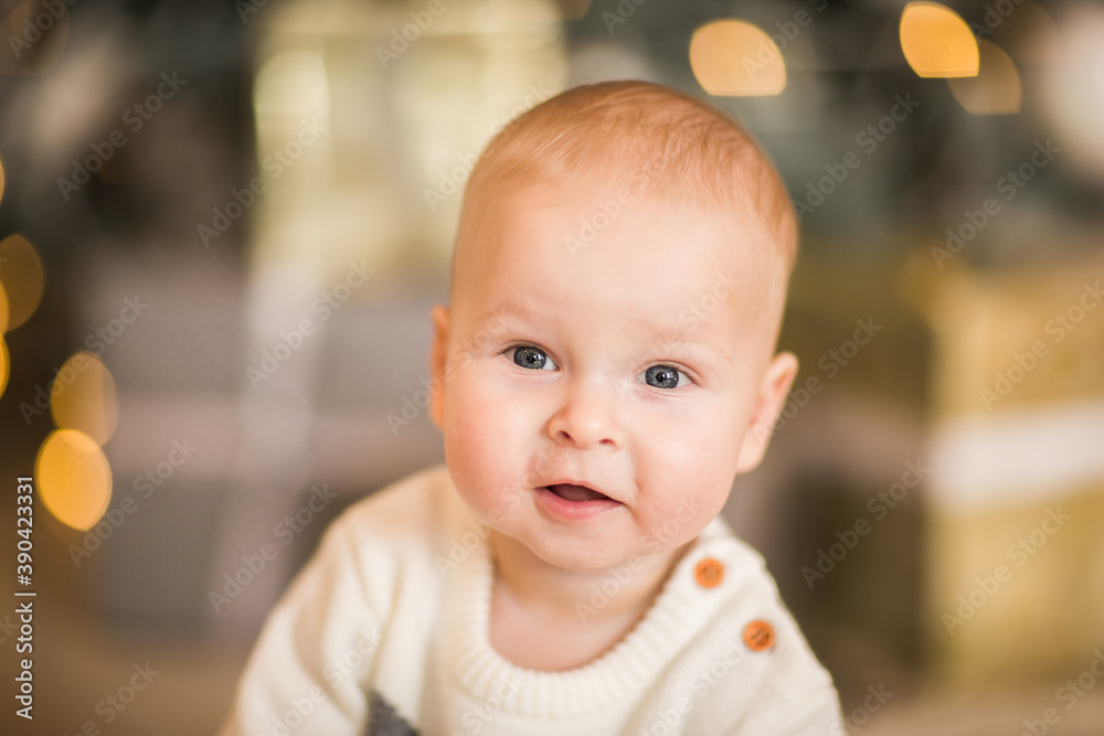 Little cute baby boy in winter body posing in the studio with decor. Copy space. Little cute baby boy in winter body posing in the studio with decor. Copy space.